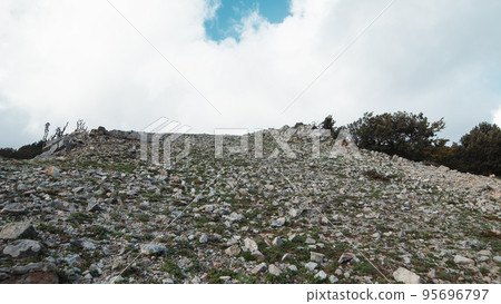 Top of a dry mountain with stones and gray soil 95696797