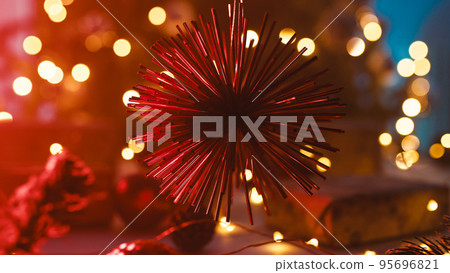 Christmas red decoration object in front of blurred tree 95696821