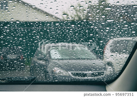 Rain drops on the glass is melancholy. Drops on car window. Inside car when raining. 95697351