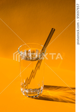 Reusable glass Straws in Glass with water on yellow background Eco-Friendly Drinking Straw Set with cleaning brush. Zero waste, plastic free concept 95697657