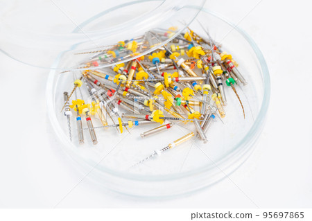 Insulated Dental Universal Pro Tapers Set. Drills for root canal treatment. White background. Petri dish with probes. Insulated Dental Universal Pro Tapers Set. Drills for root canal treatment. White background. Petri dish with probes. 95697865