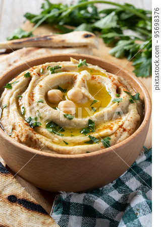 Chickpea hummus on a rustic wooden table Chickpea hummus on a rustic wooden table 95698376