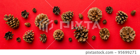 Christmas pine cones on colored paper border composition. Christmas, New Year, winter concept. Flat lay, top view, copy space 95699271