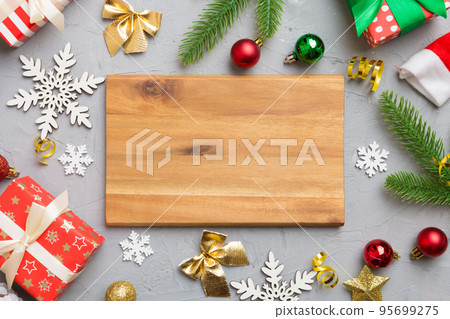 Festive table decoration with New Year branches and dekor an empty plate. Top view with space for text. Christmas time Festive table decoration with New Year branches and dekor an empty plate. Top view with space for text. Christmas time 95699275