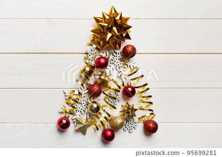 Christmas tree made from colored ball decoration on colored background, view from above. New Year minimal concept with copy space 95699281