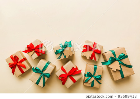 Colored craft gift boxes with colorful ribbons on colored background. Collection of Christmas present boxes 95699418