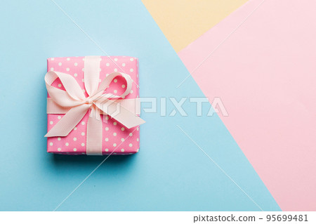 holiday paper present tied pink ribbon bow top view with copy space. Flat lay holiday background. Birthday or christmas present. Christmas gift box concept with copy space 95699481