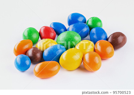 Chocolate coated Peanuts. Colorful chocolate buttons, on white background. Chocolate coated Peanuts. Colorful chocolate buttons, on white background. 95700523