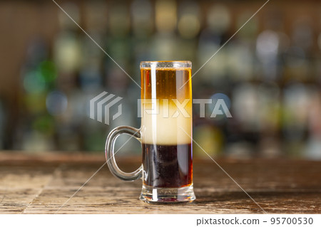 Pride of Jamaica cocktail, shots on the bar. Pride of Jamaica cocktail, shots on the bar. 95700530