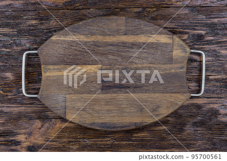 Cutting board on wood kitchen table. Food recipe concept at wood background texture with copy space. 95700561