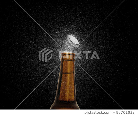 Closeup photo of an amber beer bottle splashing beer drops on a black background. Beer cap flying on top of the bottle. 3d render 95701032
