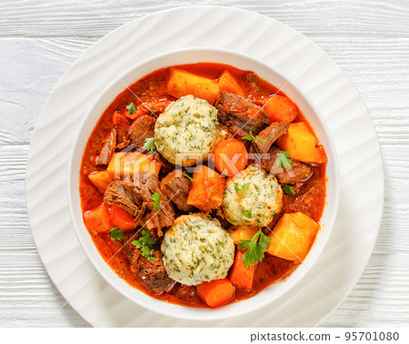 Beef Stew with Dumplings in bowl, top view Beef Stew with Dumplings in bowl, top view 95701080