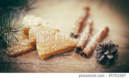 cinnamon sticks, cookies and Christmas tree branch but the tabl 95701897