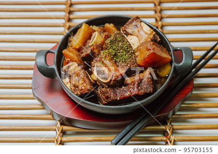 Korean food galbijjim dish on a black plate Korean food galbijjim dish on a black plate 95703155