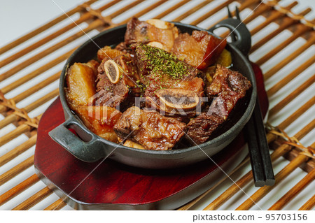 Korean food galbijjim dish on a black plate 95703156
