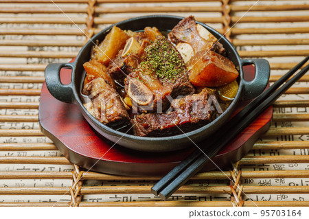 Korean food galbijjim dish on a black plate Korean food galbijjim dish on a black plate 95703164
