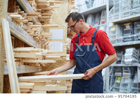 sales consultant standing near the laminate rack. sales consultant standing near the laminate rack. 95704195