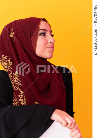 beautiful muslim woman in fashinable dress with hijab isolated on modern yellow background representing concept of modern islam and ramadan kareem beautiful muslim woman in fashinable dress with hijab isolated on modern yellow background representing concept of modern islam and ramadan kareem 95704466