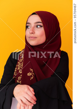 beautiful muslim woman in fashinable dress with hijab isolated on modern yellow background representing concept of modern islam and ramadan kareem beautiful muslim woman in fashinable dress with hijab isolated on modern yellow background representing concept of modern islam and ramadan kareem 95704467