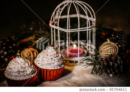 cupcakes,Christmas candle and Christmas decorations on wooden ba 95704611