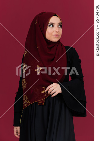 beautiful muslim woman in fashinable dress with hijab isolated on modern red background representing concept of modern islam and ramadan kareem beautiful muslim woman in fashinable dress with hijab isolated on modern red background representing concept of modern islam and ramadan kareem 95704706