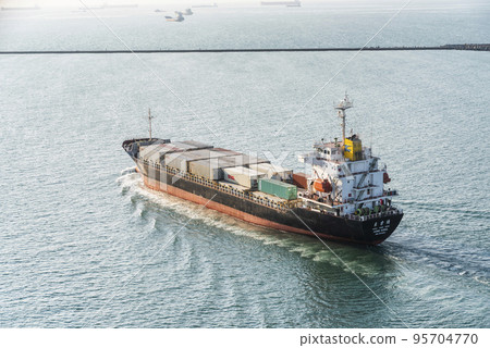 The container ship is leaving the Port of Kaohsiung, Taiwan. 95704770