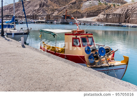 Small fishing boat in a port of Santorini 95705016