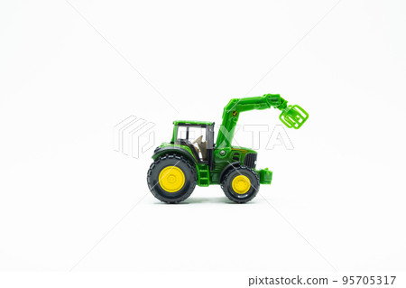 Green and yellow Tractor toy on white background Green and yellow Tractor toy on white background 95705317