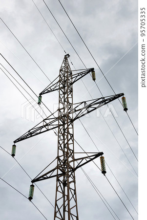 Pylons and power lines.High-voltage line fastened on a tower truss. 95705335