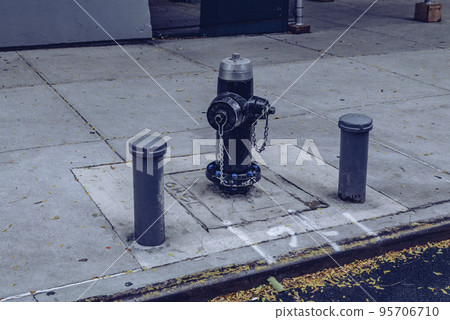 Classic Black US-style fire hydrant seen installed on a New York sidewalk. Classic Black US-style fire hydrant seen installed on a New York sidewalk. 95706710