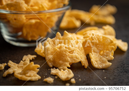 Halloween crispy bat shaped chips on dark table. 95706752