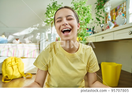 Adolescent teenage girl student having video call, looking at webcam Adolescent teenage girl student having video call, looking at webcam 95707805