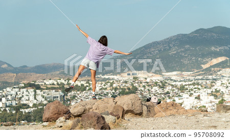 A woman on the observation deck with her arms open looks at the city and the sea from a height - travel, freedom, life A woman on the observation deck with her arms open looks at the city and the sea from a height - travel, freedom, life 95708092