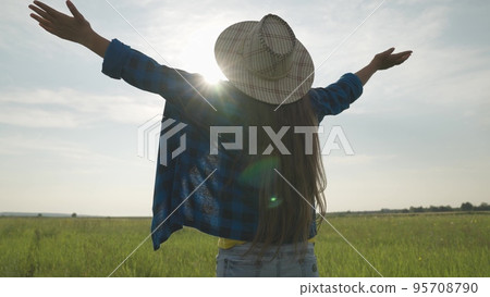 farmer in hat enjoys warmth of setting above field sun farmer in hat enjoys warmth of setting above field sun 95708790