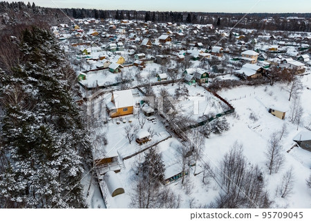 Summer cottages covered with white snow in winter, aerial view 95709045