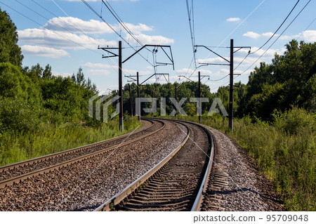Turning railway tracks in a forest area Turning railway tracks in a forest area 95709048