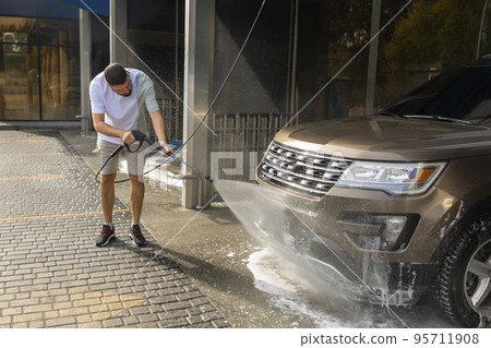 He loves his car. Man washing car. He loves his car. Man washing car. 95711908