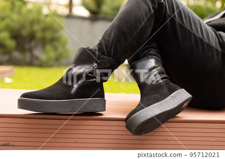 Elegant womens shoes on the foot on the street. Comfort and fashion 95712021