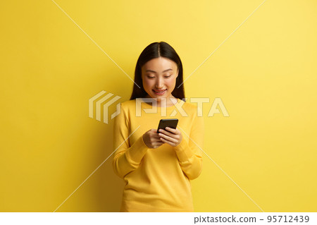 Happy Woman Holding Smartphone Isolated. Asian Girl Messaging Cellphone Happy Woman Holding Smartphone Isolated. Asian Girl Messaging Cellphone 95712439