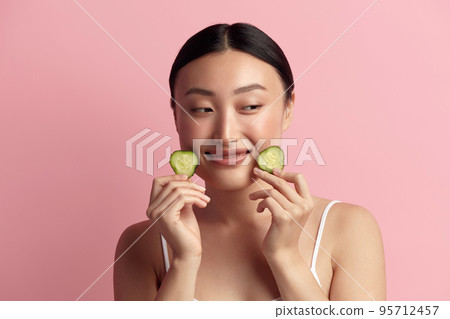 Asian Woman Holding Cucumber. Portrait of Beautiful Girl Hold Slice of Cucumber 95712457