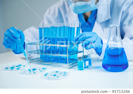 Asian young student scientist researching and new chemical substances in a laboratory. Asian young student scientist researching and new chemical substances in a laboratory. 95713286