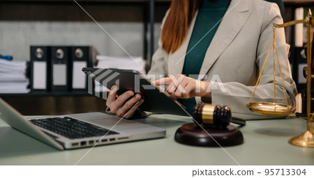 justice and law concept.Male judge in a courtroom the gavel, working with smart phone and laptop and digital tablet computer on white table justice and law concept.Male judge in a courtroom the gavel, working with smart phone and laptop and digital tablet computer on white table 95713304