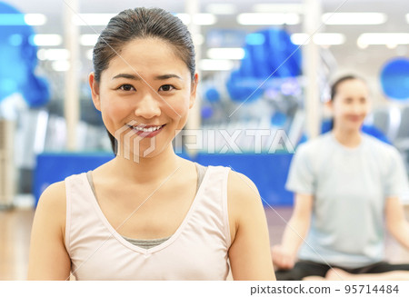 A woman who works for yoga at a sports club A woman who works for yoga at a sports club 95714484