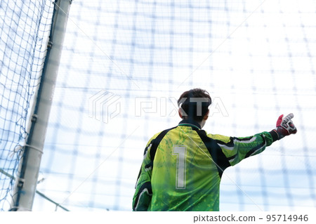 Goalkeeper man catching a soccer ball Goalkeeper man catching a soccer ball 95714946