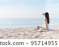 Vacation on the beach, Young woman relaxing on the beach in summer 95714955