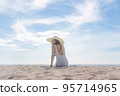 Summer vacation on the beach, Young woman relaxing on the beach with sea view	 95714965