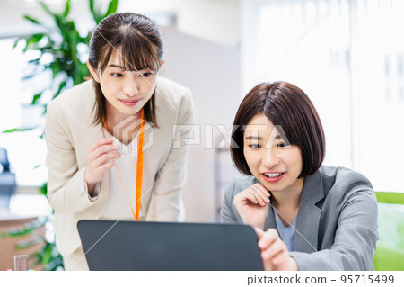 Business woman heading to PC at office 95715499