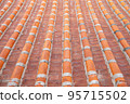 Vintage rooftop tile pattern, a close up of traditional ancient colorful tiles for background wallpaper. 95715502