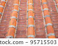 Vintage rooftop tile pattern, a close up of traditional ancient colorful tiles for background wallpaper. 95715503