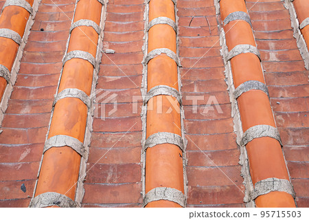 Vintage rooftop tile pattern, a close up of traditional ancient colorful tiles for background wallpaper. Vintage rooftop tile pattern, a close up of traditional ancient colorful tiles for background wallpaper. 95715503